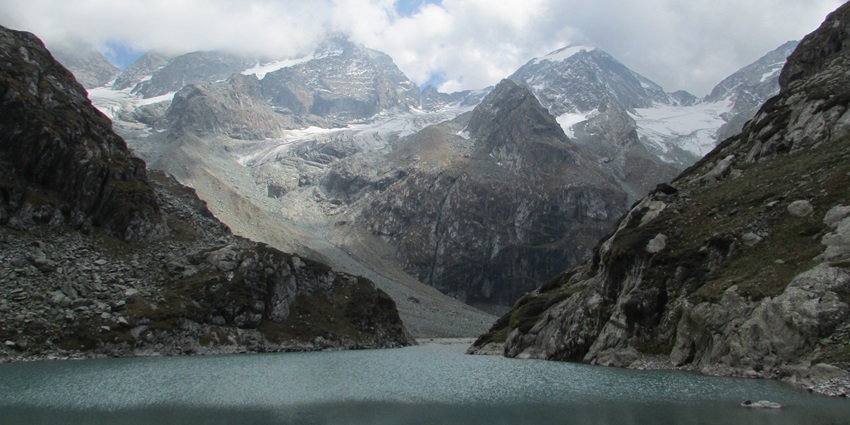 Glacial lake near Pahalgam, Kashmir surrounded by snow-capped peaks and meadows, popular among high-altitude trekking enthusiasts, one of the best frozen lakes in Kashmir.