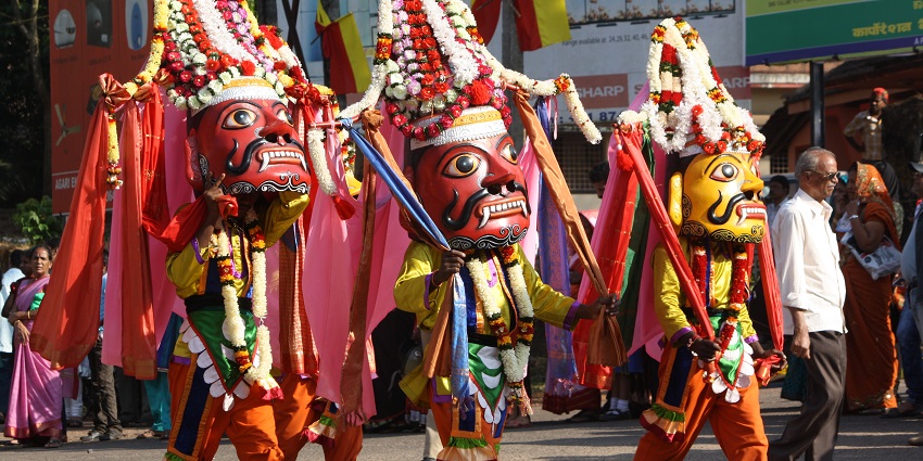 An image showing people wearing traditional masks during the Ugadi festival celebrations