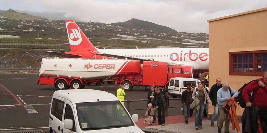 Exhausted passengers going towards the airport to collect their luggage after landing.