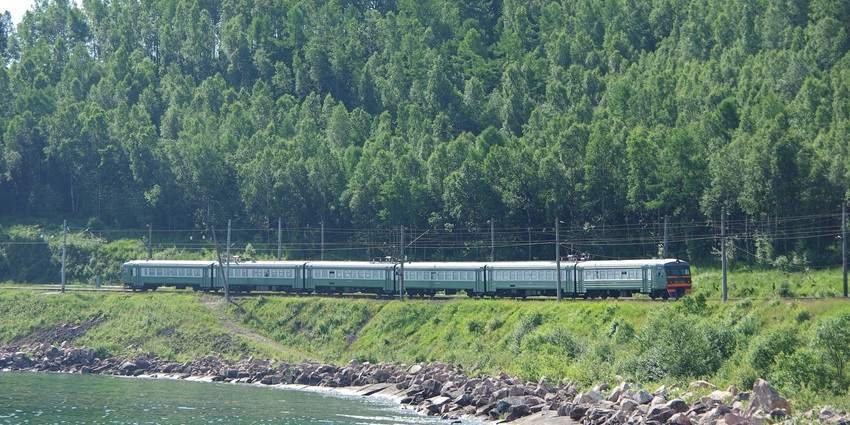 Ullan ude with a small green train and electricity wires near the deepest lake in Russia.
