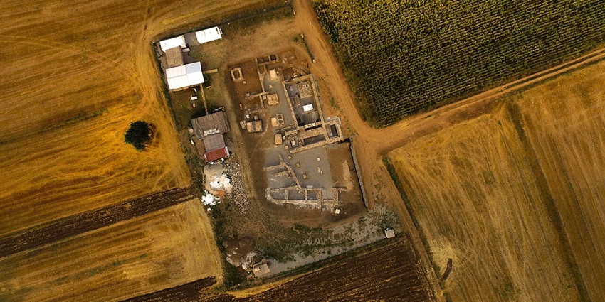 Aerial view of the ancient Roman city of Ulpiana in Kosovo, revealing excavated ruins, stone foundations, and historical layout.
