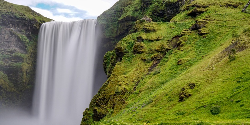A waterfall cascading down mountains, representing dangerous waterfalls in India.