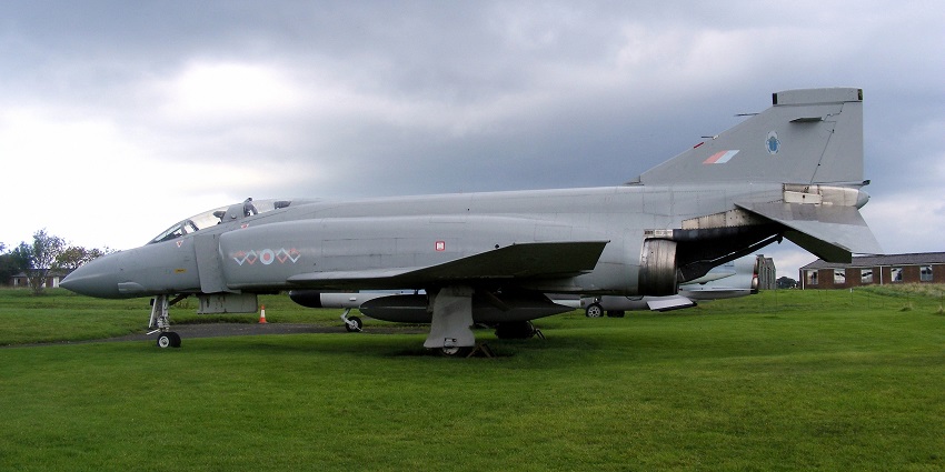 A view of small grey aircraft landed on green grass at one of the airports in Luxembourg.