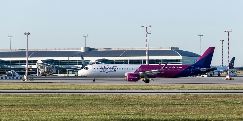 Wizz Air airplane taxiing at Václav Havel Airport Prague terminal on a clear day.