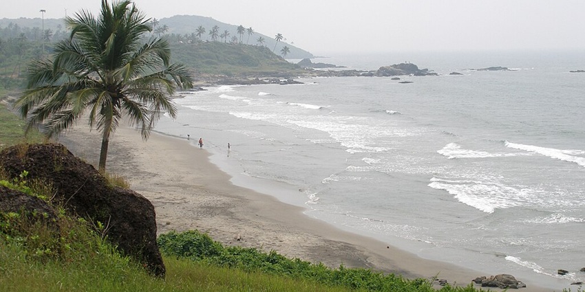 An aerial view of Vagator Beach, one of the best places for camping in Goa, India.