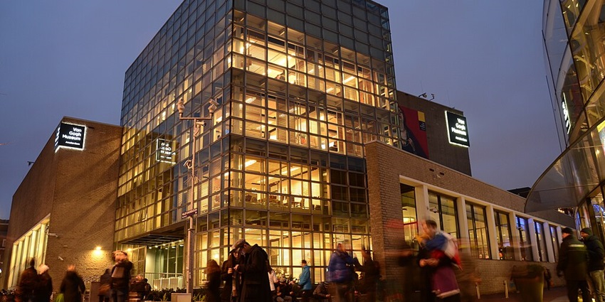 The Van Gogh Museum in Amsterdam with its modern architecture and visitors nearby.
