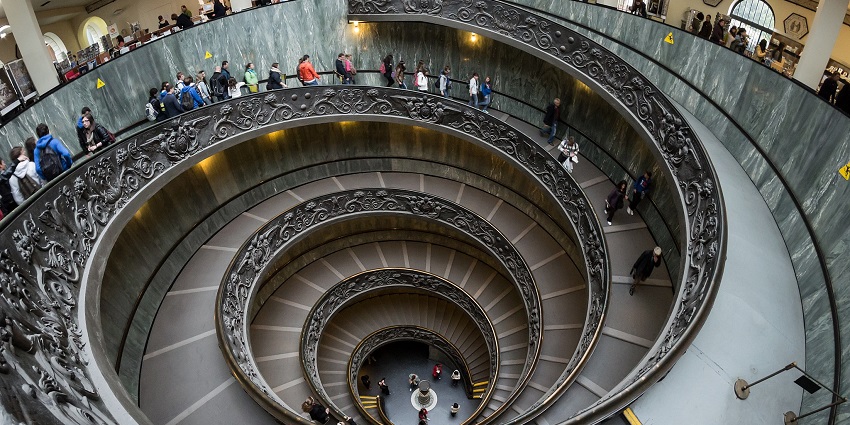 Tourists exploring and climbing the famous ‘Spiral Staircase’ at the Vatican Museums.