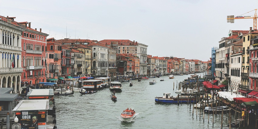 A picturesque Venetian canal with traditional boats, reflecting the charm of Italy.
