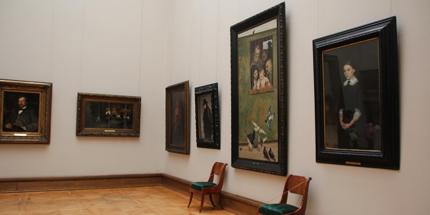 An image showing a museum interior with chairs and paintings, similar to Village Complex, New Delhi