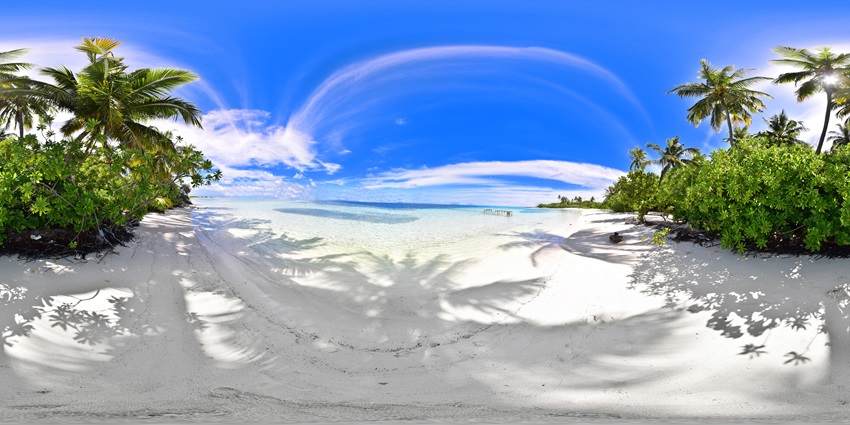 A scenic view of Villingili Island in Male Island featuring palm trees and golden shores.
