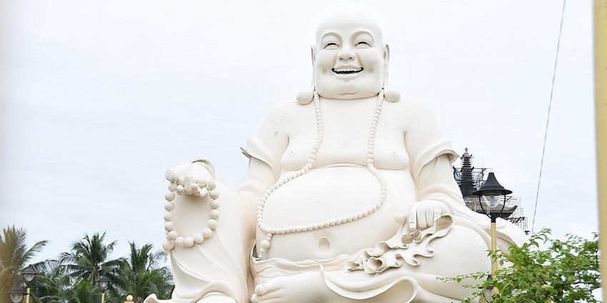 Image of the Giant Budai statue in Vinh Trang, one of the beautiful places to visit in Mekong Delta.