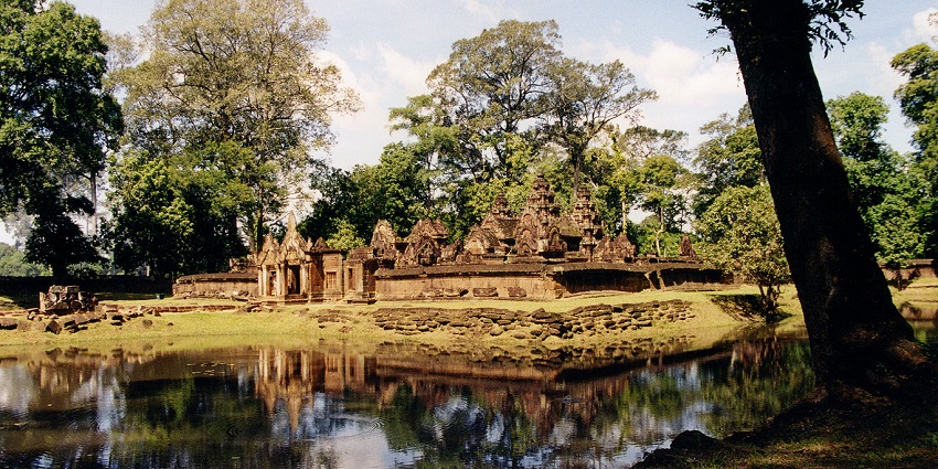 An image of the Banteay Srei, reflected in a pond, visiting it is one of the great things to do in Cambodia in October