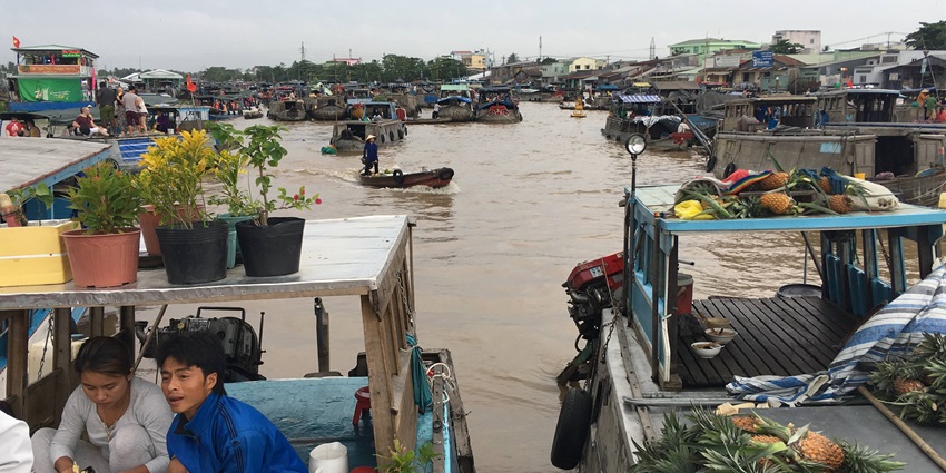 An image showing boats at Cai Rang Floating Market, one of the top things to do in Mekong Delta.