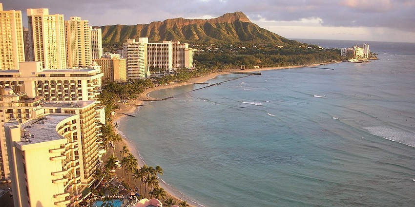 An image showing a serene sunset at Waikiki Beach, the best place near Hawaiian islands.