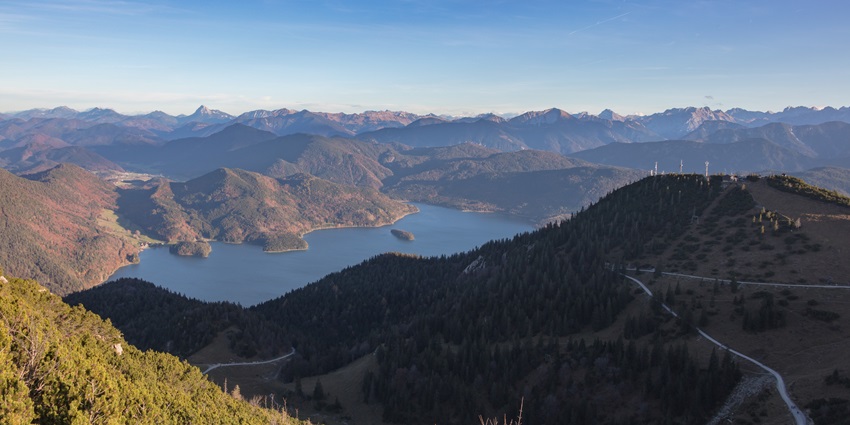 A picturesque island in the deep-blue Walchensee Lake, surrounded by the Bavarian Alps
