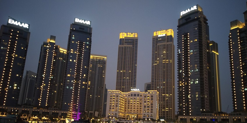 Dubai Marina skyline glows at dusk, with luxurious waterfront towers and yachts in view