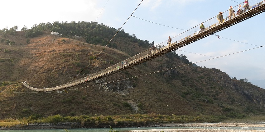 An image of people walking on the Punakha Suspension Bridge, one of the best things to do in Punakha