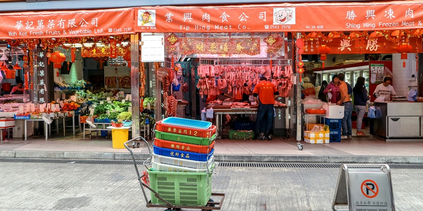 Image of the lively shops of Kee Ann Street Market with visitors wandering around.