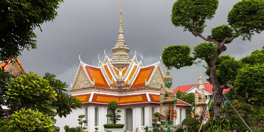 Wat Arun in Bangkok, Thailand, showcasing its ornate spires and intricate architectural details.