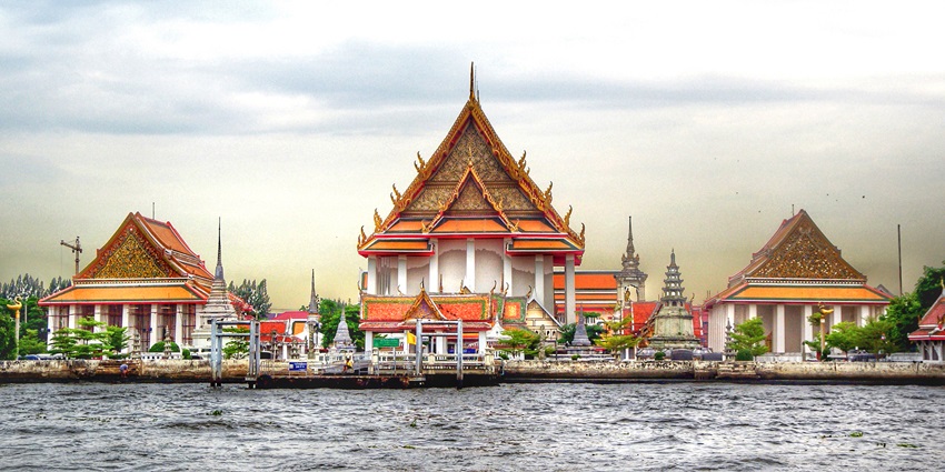 Admire the majestic Buddha statue and riverside views at this historic Bangkok temple