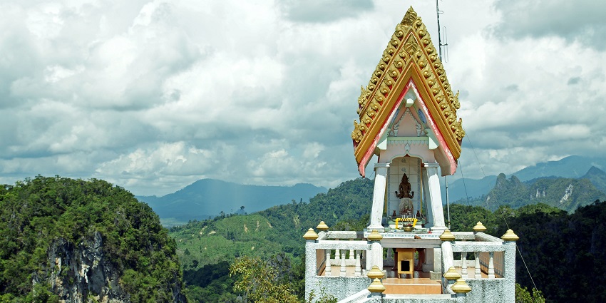 The stunning golden Buddha statue at Wat Tham Sua sitting on a hilltop.