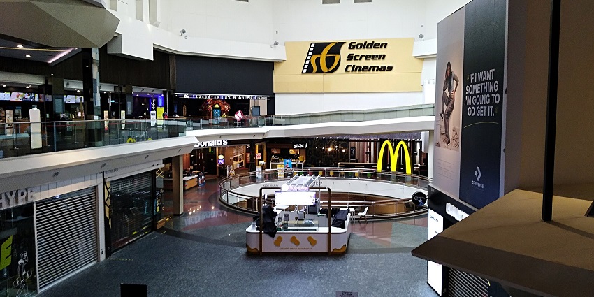 A shopping mall interior with Golden Screen Cinemas, McDonald's, and various retail stores