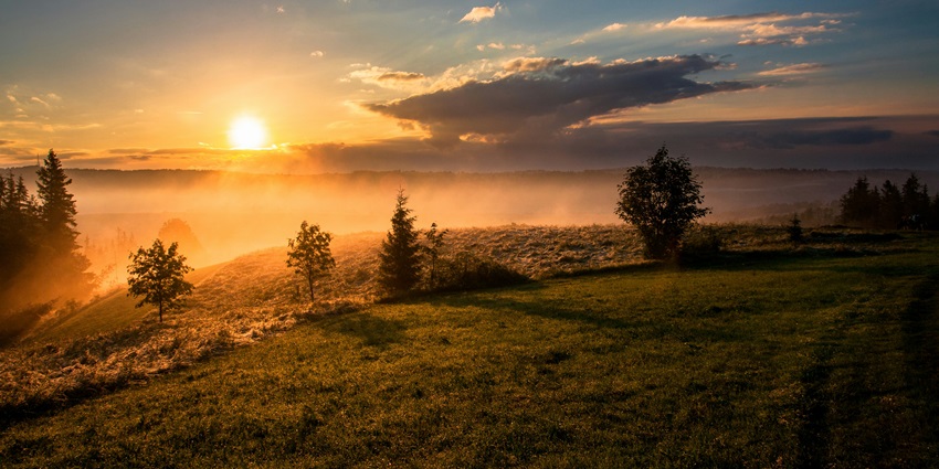 Image of a sunrise from the mountains with picturesque views and clouds