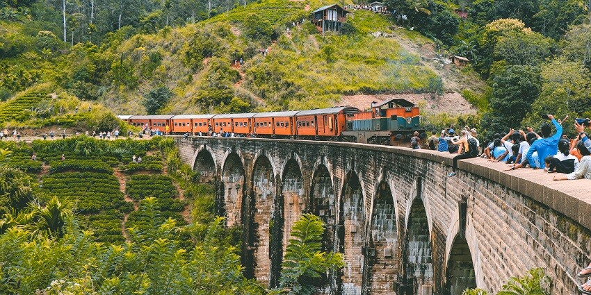 A train passing through the bridge offering picturesque views