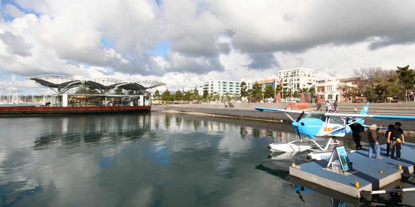 A lively view of Waterfront Geelong with sculptures and clear water during the daytime.