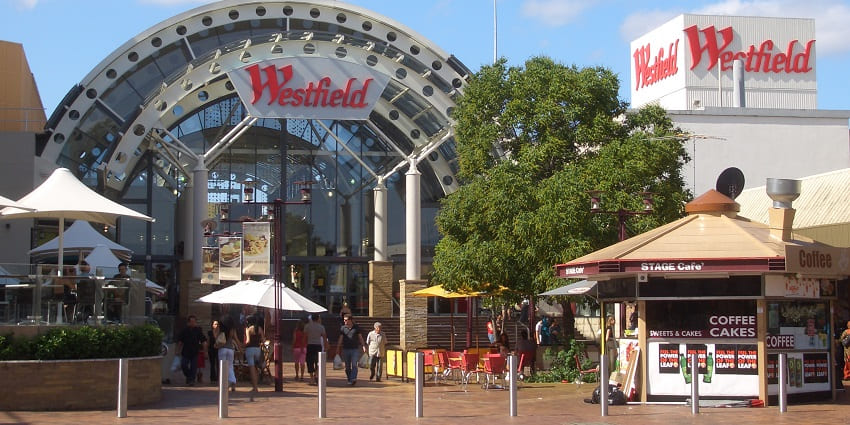 Westfield complex in Liverpool with glass-structured buildings and people walking