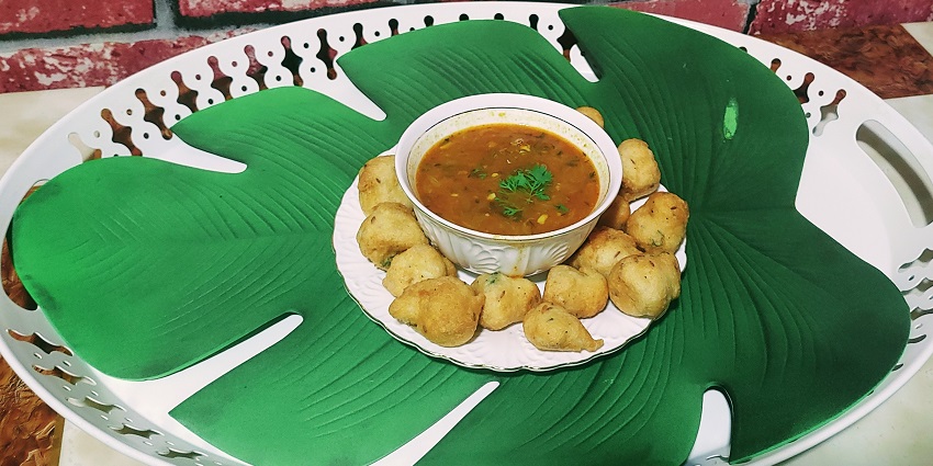 Maharashtrian style Medu vada with multiple wada and curry served on a white plate and bowl