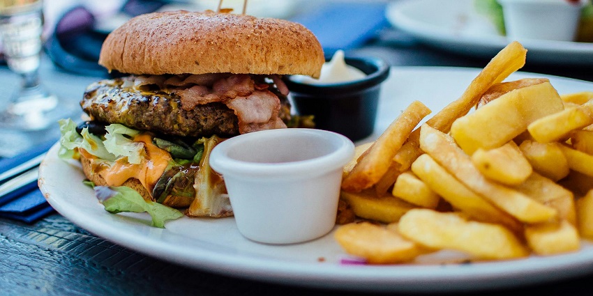 Image of a plate of burger and fried served on a plate with delicious looking
