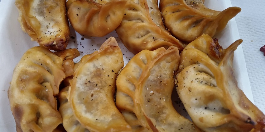 Traditional Bhutanese momos, a delicious local cuisine, with a warm and welcoming taste.