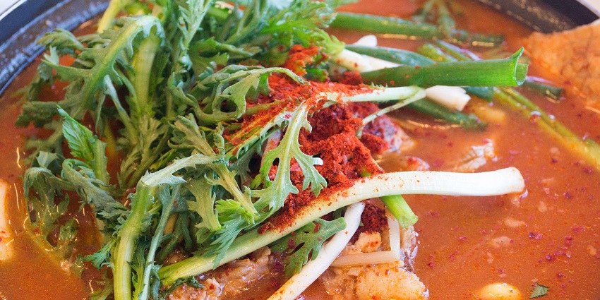 A warm bowl of traditional Bhutanese ema datshi, a staple meal for those on Bhutan treks.