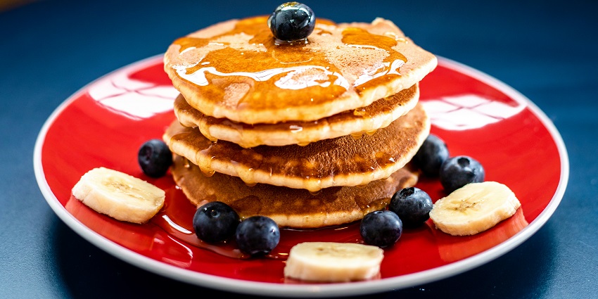 Image of pancakes with honey top and blueberries on top with delicious food in the Great Rift Valley