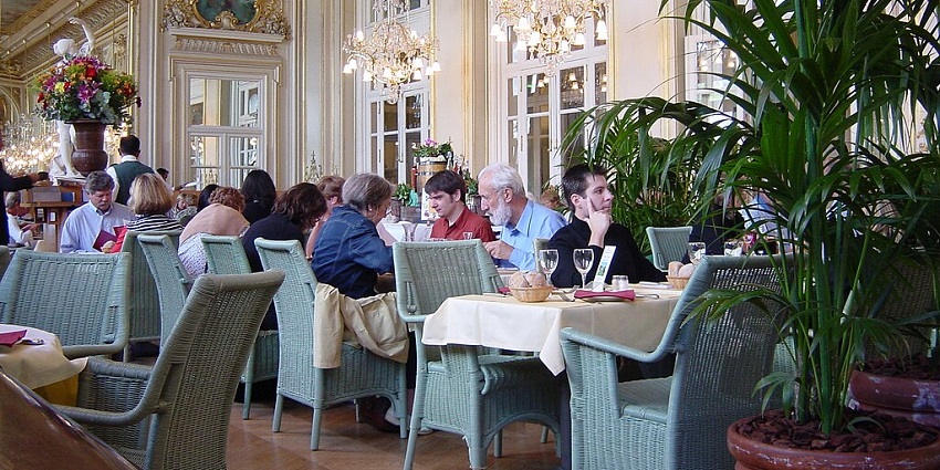 A picture of people at one of the many, bustling and elaborate KL restaurants.