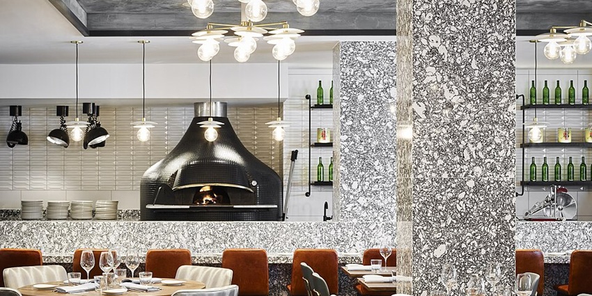 Fine dining restaurant decked up with classy seating arrangements and a variety of lights.