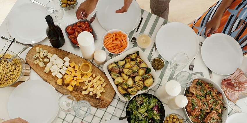 An image of a celebratory meal, raising glasses at a wooden table near Sutherland Falls.