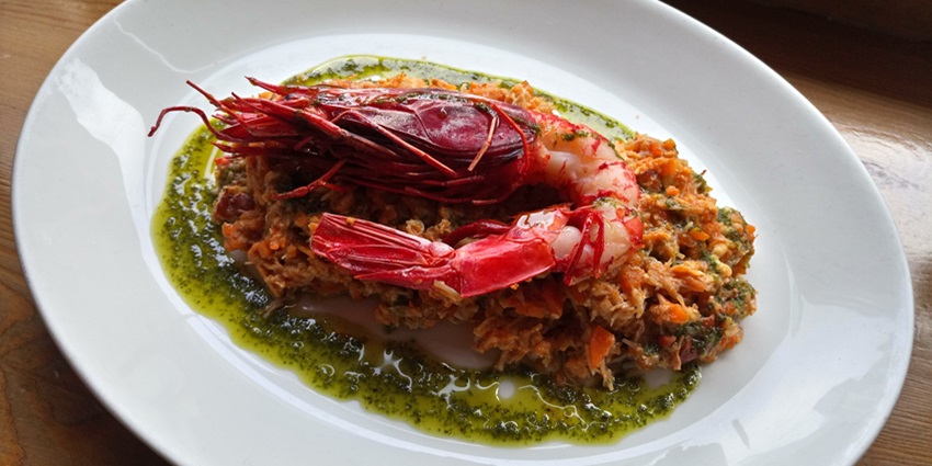 A dining experience at The Raw Prawn Seafood Restaurant featuring fresh seafood dishes.