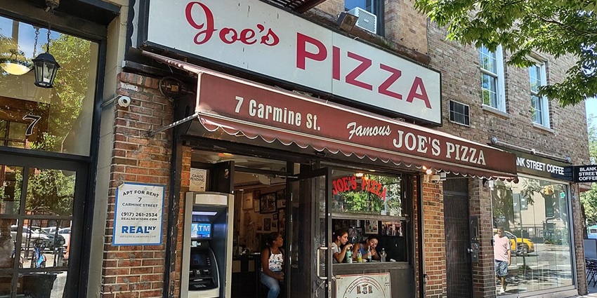 Customers wait inside the Joe’s Pizza shop in Greenwich Village of New York City.
