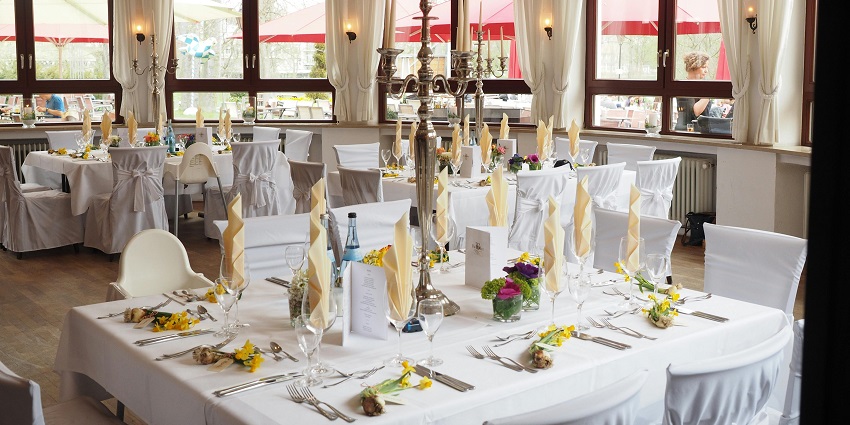 An image of a restaurant table with a grey candelabra as part of the table setting