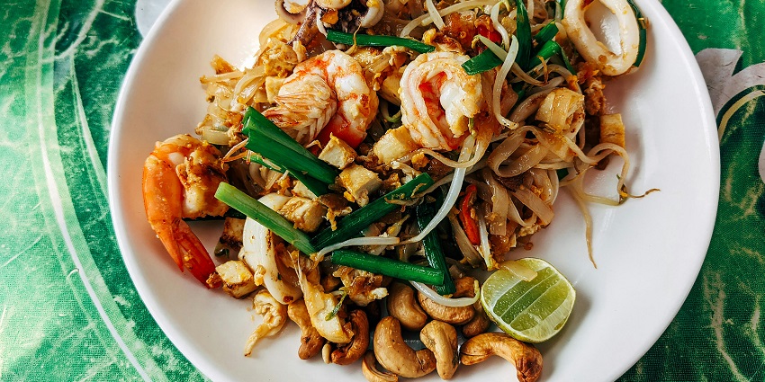 Enjoy Pad Thai at a restaurant in Bangkok, Thailand when visiting this monument