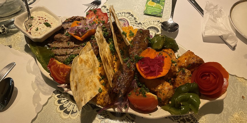 An image of a cosy restaurant in Uchisar serving authentic Turkish cuisine with a backdrop of Cappadocia’s scenic valleys.