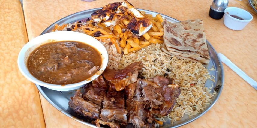 Traditional Kenyan Swahili dish with flavorful spices and vibrant side accompaniments