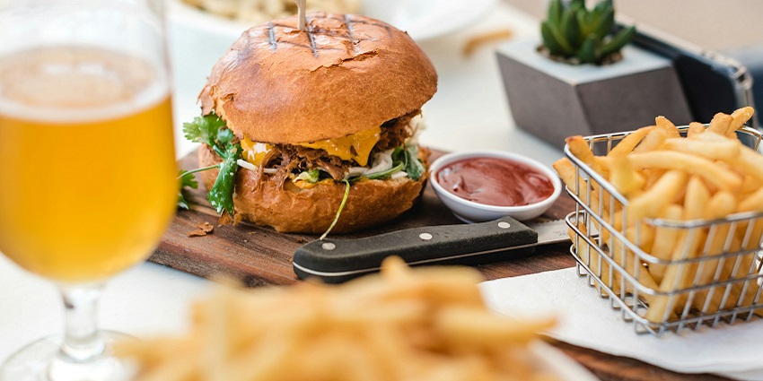 An image burger and fires served on a table - ready to devour this delectable food