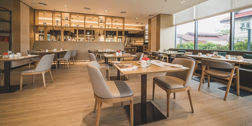 A restaurant in minimal style with a plush sitting area in front of a kitchen counter