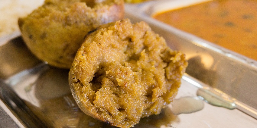 An image of a dish called Daal Bafla, which is one of the traditional Rajasthani cuisine