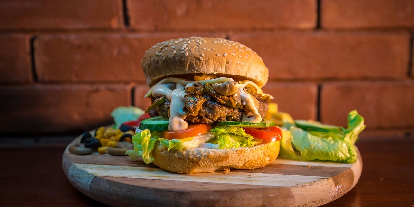 Classic American burger with different sauces to try near the deepest lake in Michigan.