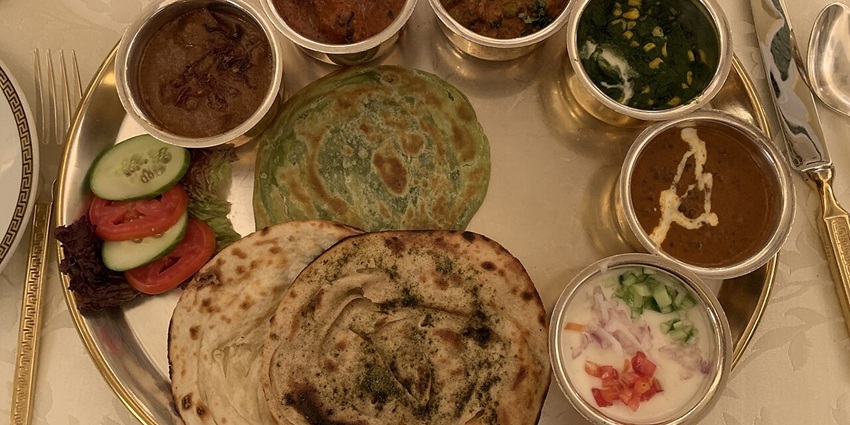 An image of Royal Rajasthani thali served with traditional curries and breads
