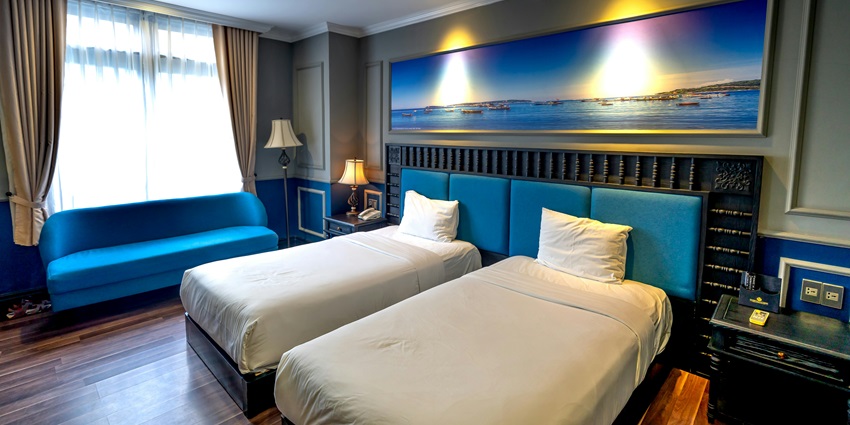 Deluxe hotel suite bed with plush comforters and elegant decor for a dreamy night at Lamai beach